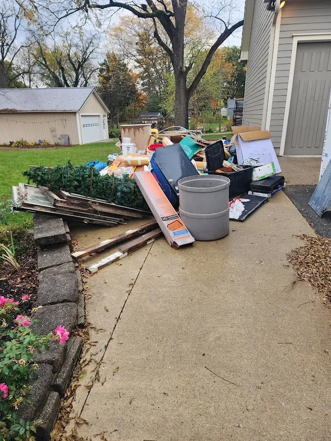 Dumpster being loaded with debris for Estate Cleanout Dumpster Rental in Castleton